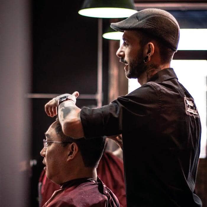 Business Loans for Barber Shops - Barber cutting clients hair