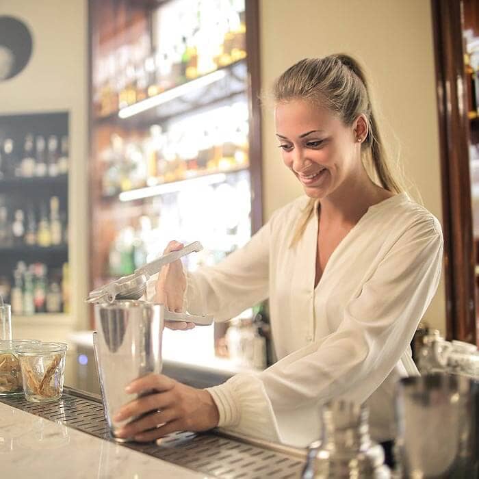 Business Loans for Pubs, Bars & Clubs - Female bartender serving cocktail in elegant bar
