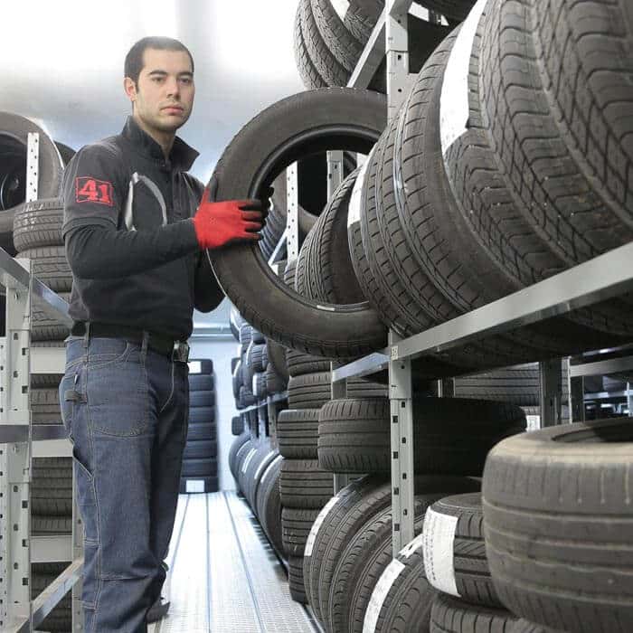 Business Loans for Tyre Fitters - Fitter choosing the right tyre size for customer