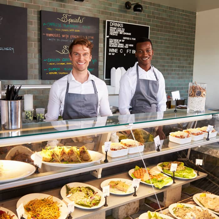 Staff behind counter at local delicatessen