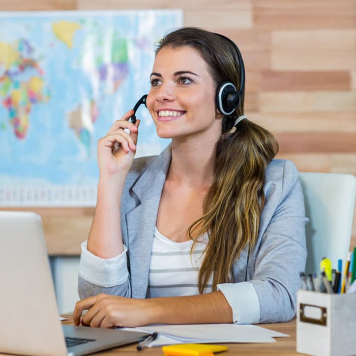 Travel agent speaking with a customer over the phone